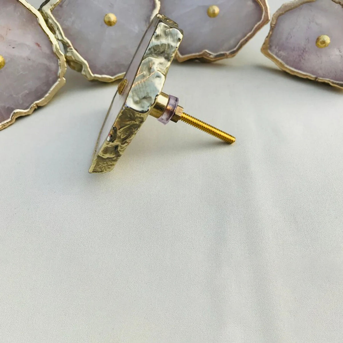 Rose quartz slice knob turned to show its bolt
