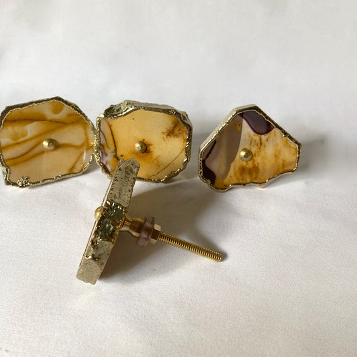 Mookaite slice knobs with one lying on its edge to show its bolt
