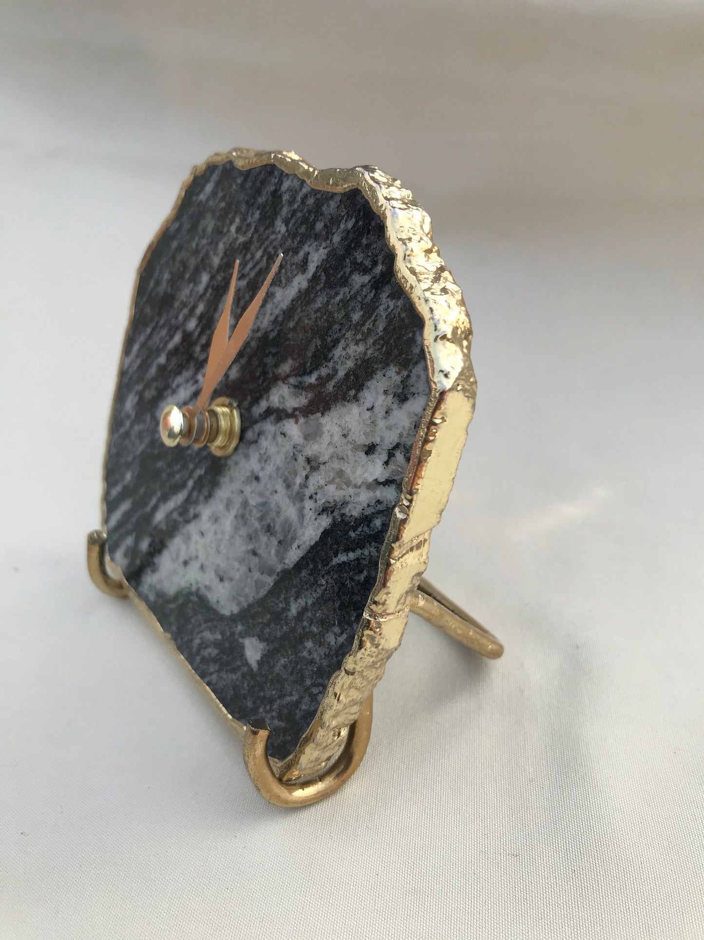 Brass hands and electroformed edges on zebra agate