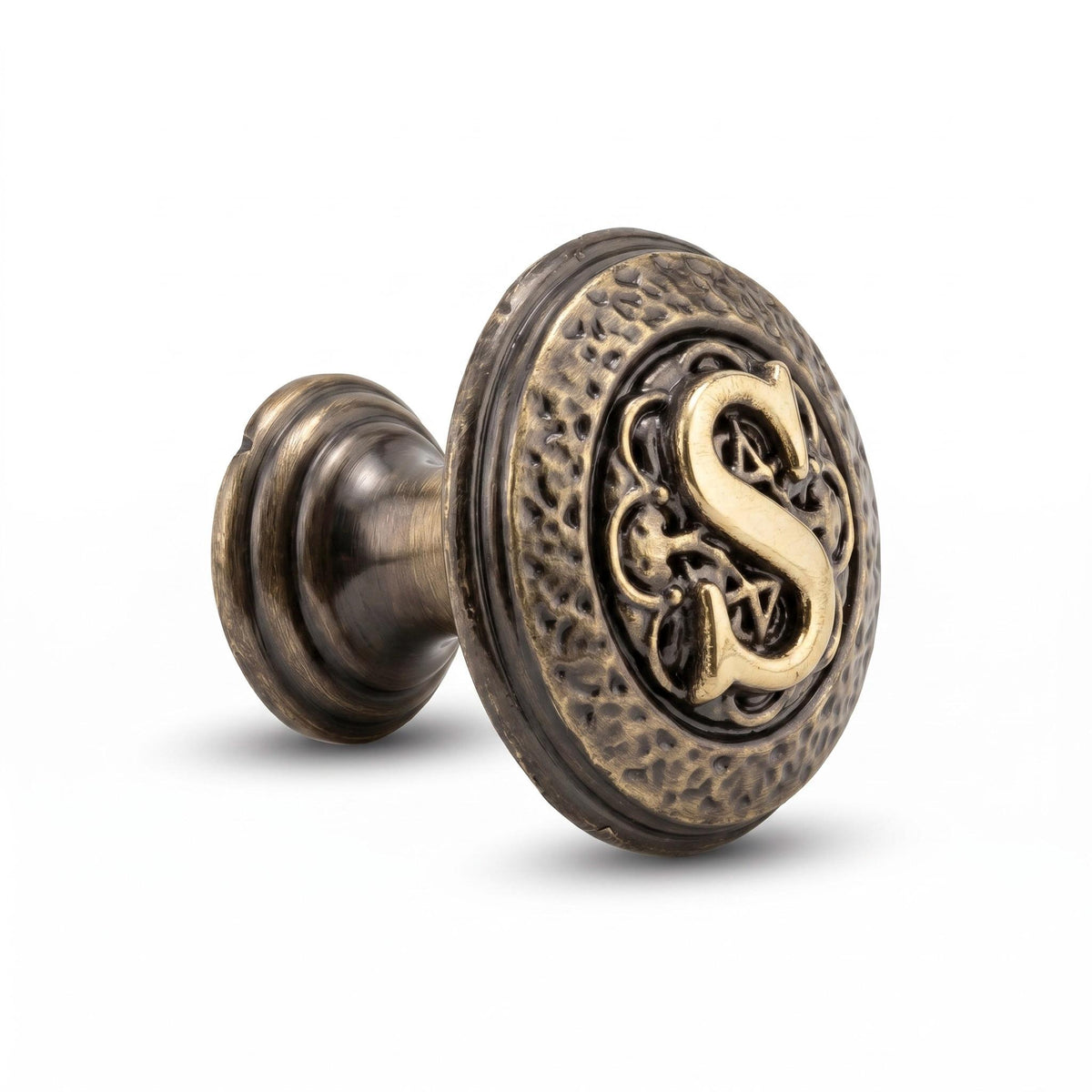 An S initial knob from the side, showing its stem and base