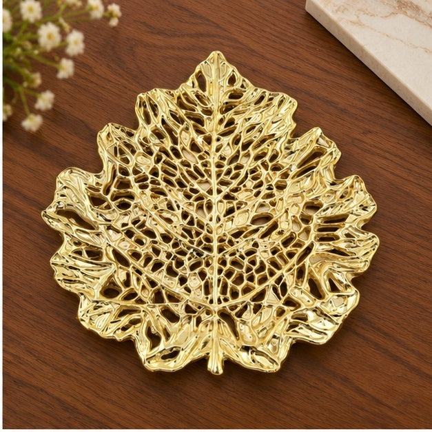 Skeleton leaf tray in gold on a wooden table