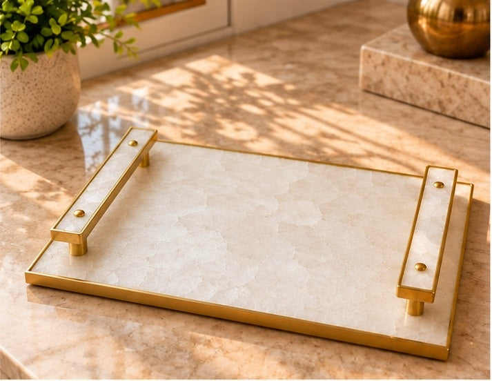 
White crystal agate tray with pale stone-inlaid bar handles in a gold finish, shown on a table