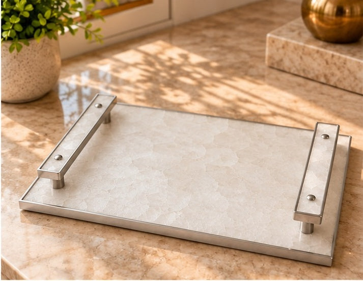 
White crystal agate tray with pale stone-inlaid bar handles in a silver finish, shown on a table