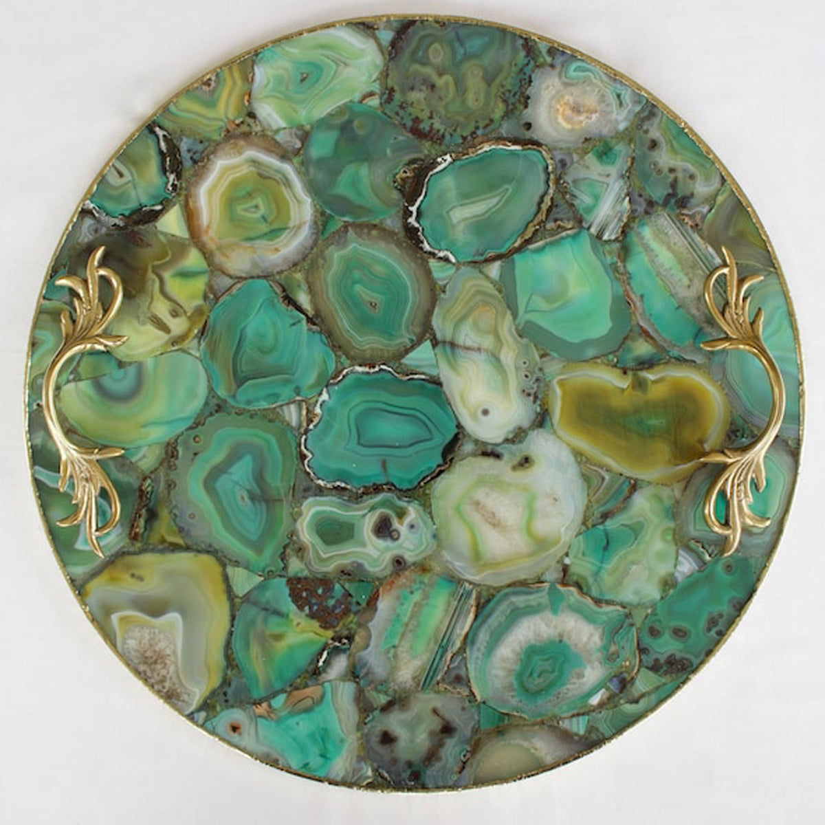 Rose gold finish over the brass handles of a green agate tray