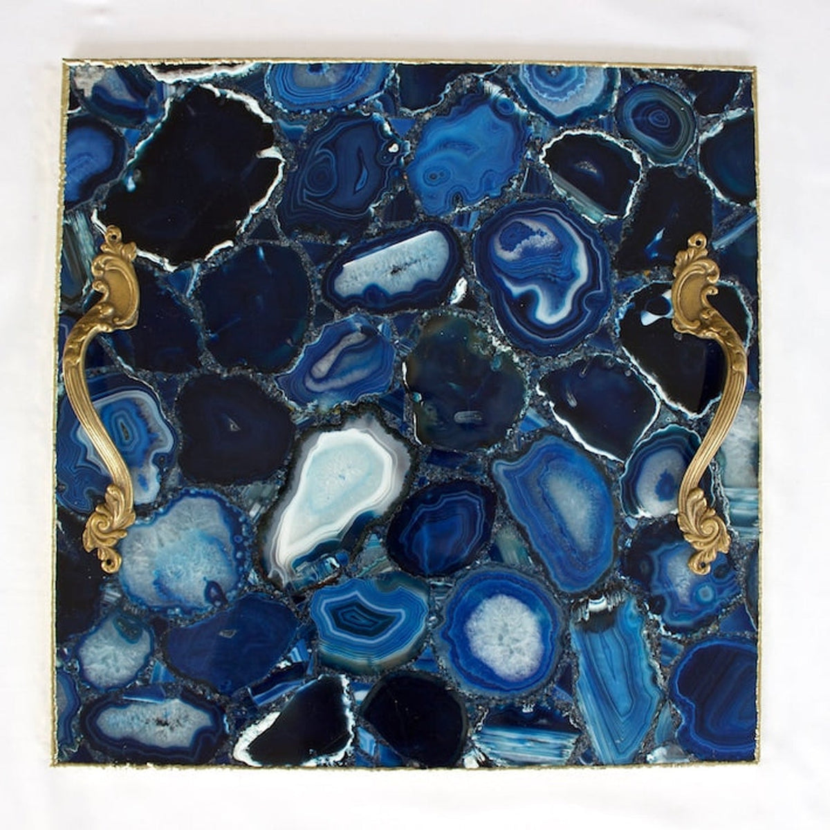 Brass handles fitted to a blue agate tray