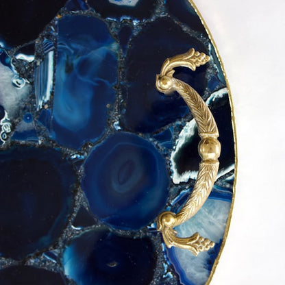Solid brass handles bolted to a circle of blue agate