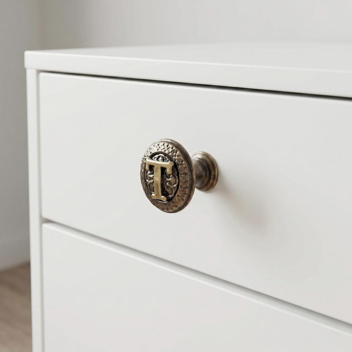 A T knob on a white drawer