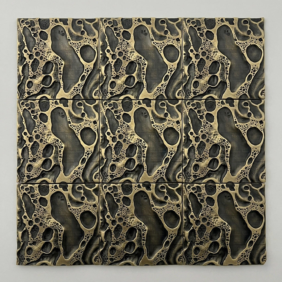 Nine cosmic crater tiles in antique brass