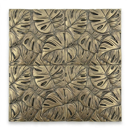Four monstera leaf tiles in antique brass, set in a square