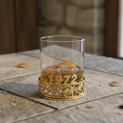 The back of the glass reading 1972, on a slate tile