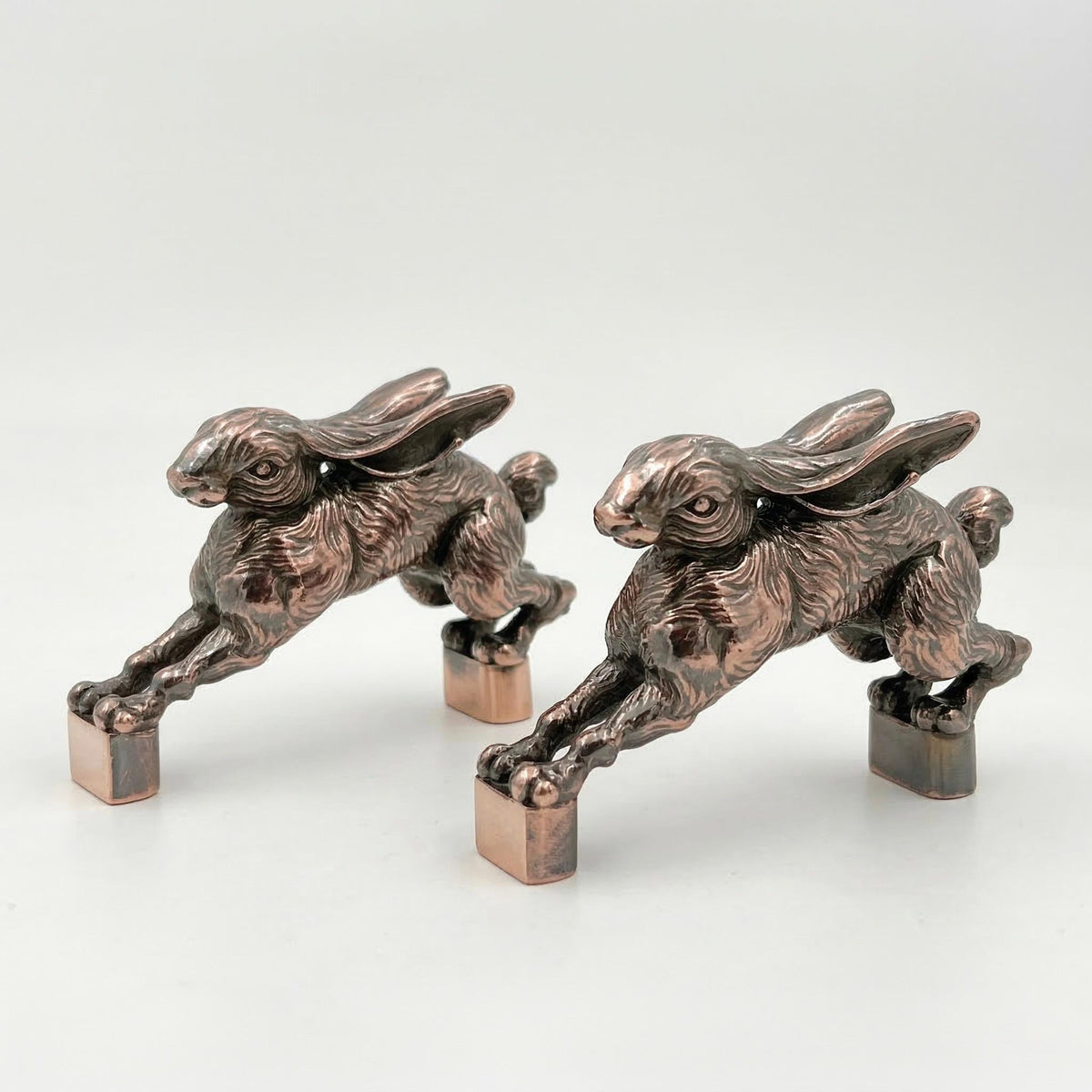 Two hopping hare handles in antique copper