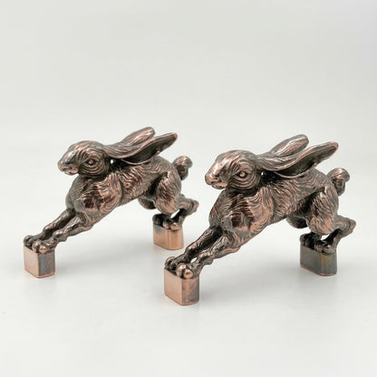 Two hopping hare handles in antique copper