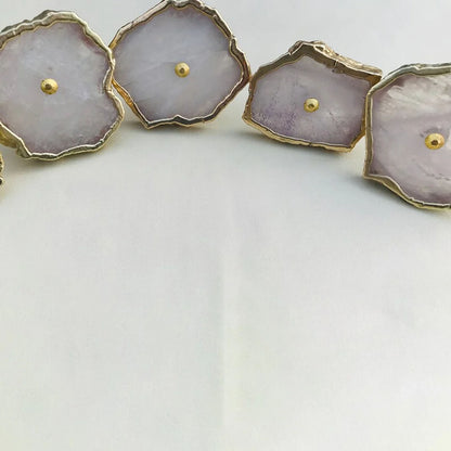 Rose quartz slice knobs in a curve, close-up