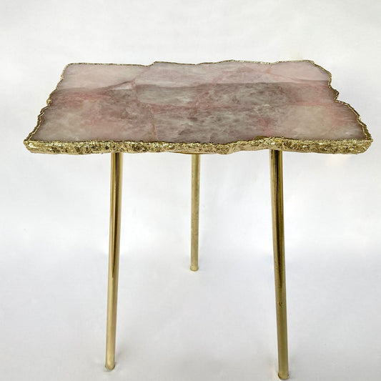
Rose quartz slab side table with a natural stone top and slim gold legs, full view