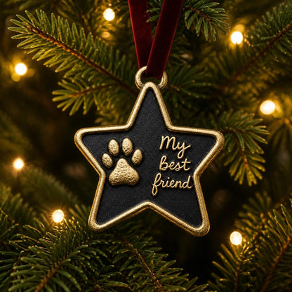 Star paw print ornament hanging on a lit Christmas tree