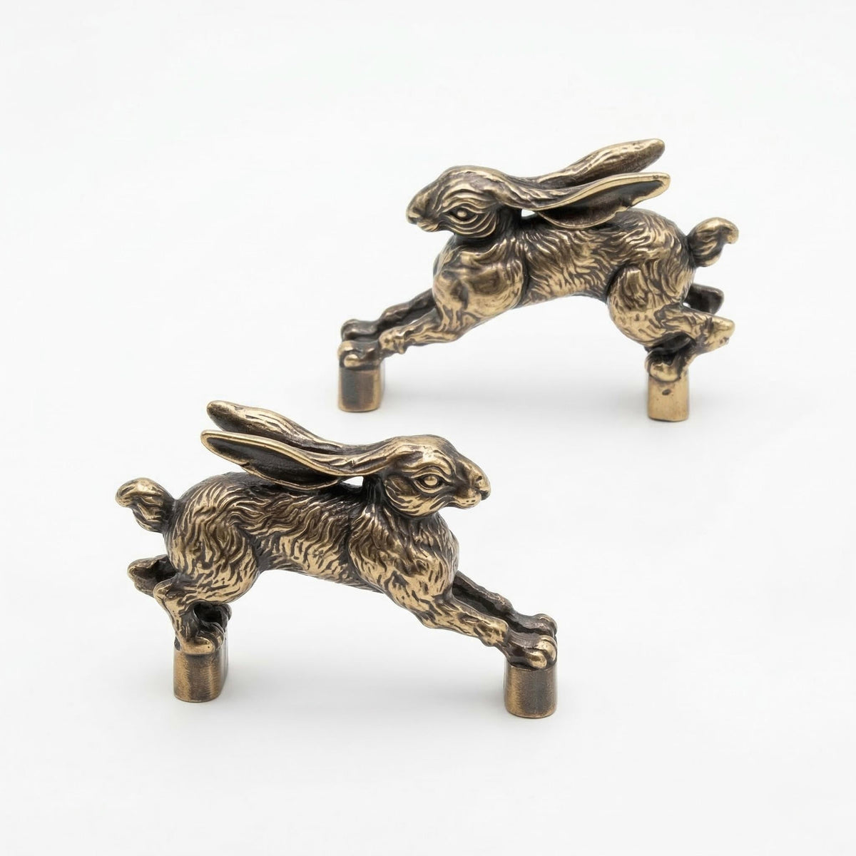 Two hopping hare handles in antique brass