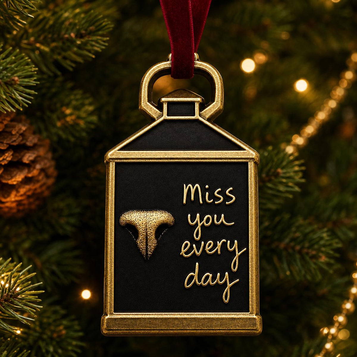 Lantern nose print ornament hanging on a lit Christmas tree with pine cones