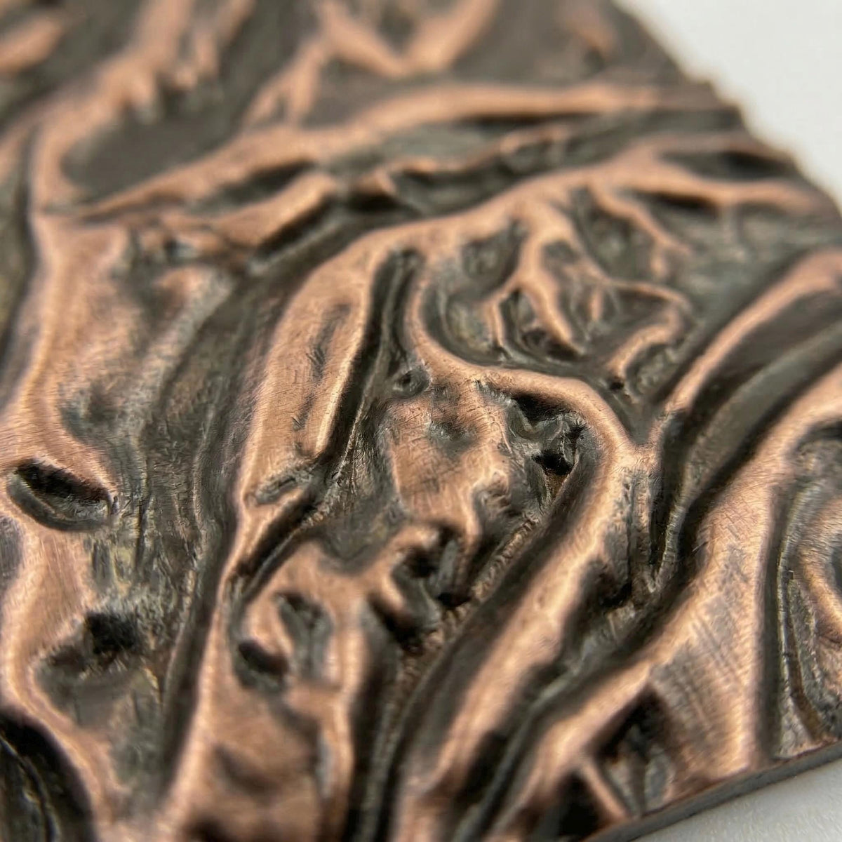 Close-up of the flowing ridges in antique copper