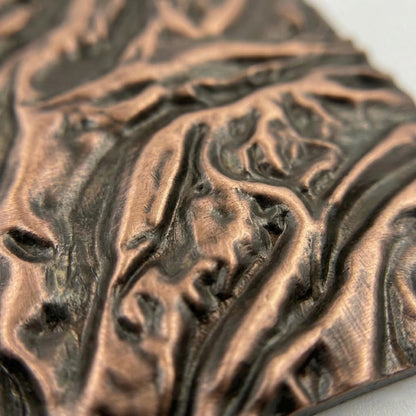 Close-up of the flowing ridges in antique copper
