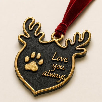 Close angled view of the antlered ornament with the raised paw print and script lettering