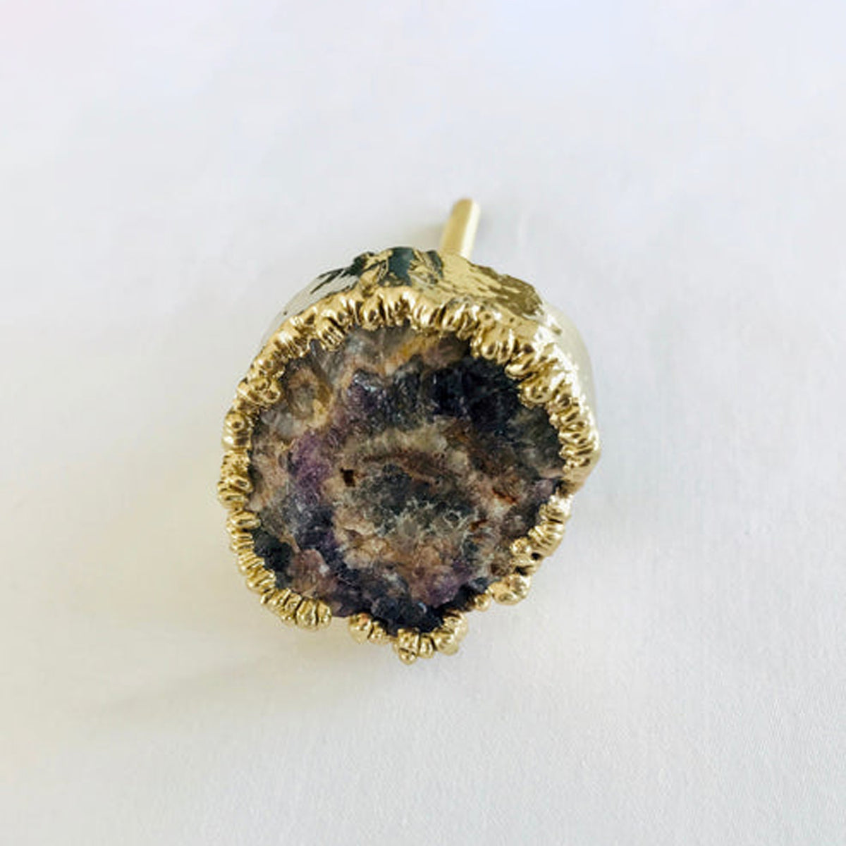Amethyst geode knob with a rough crystal center in brown and violet and a gold edge