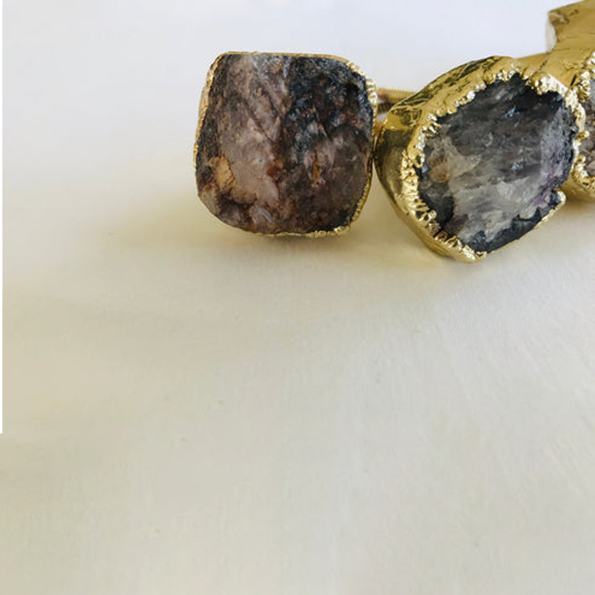 Two raw amethyst geode knobs with gold edges