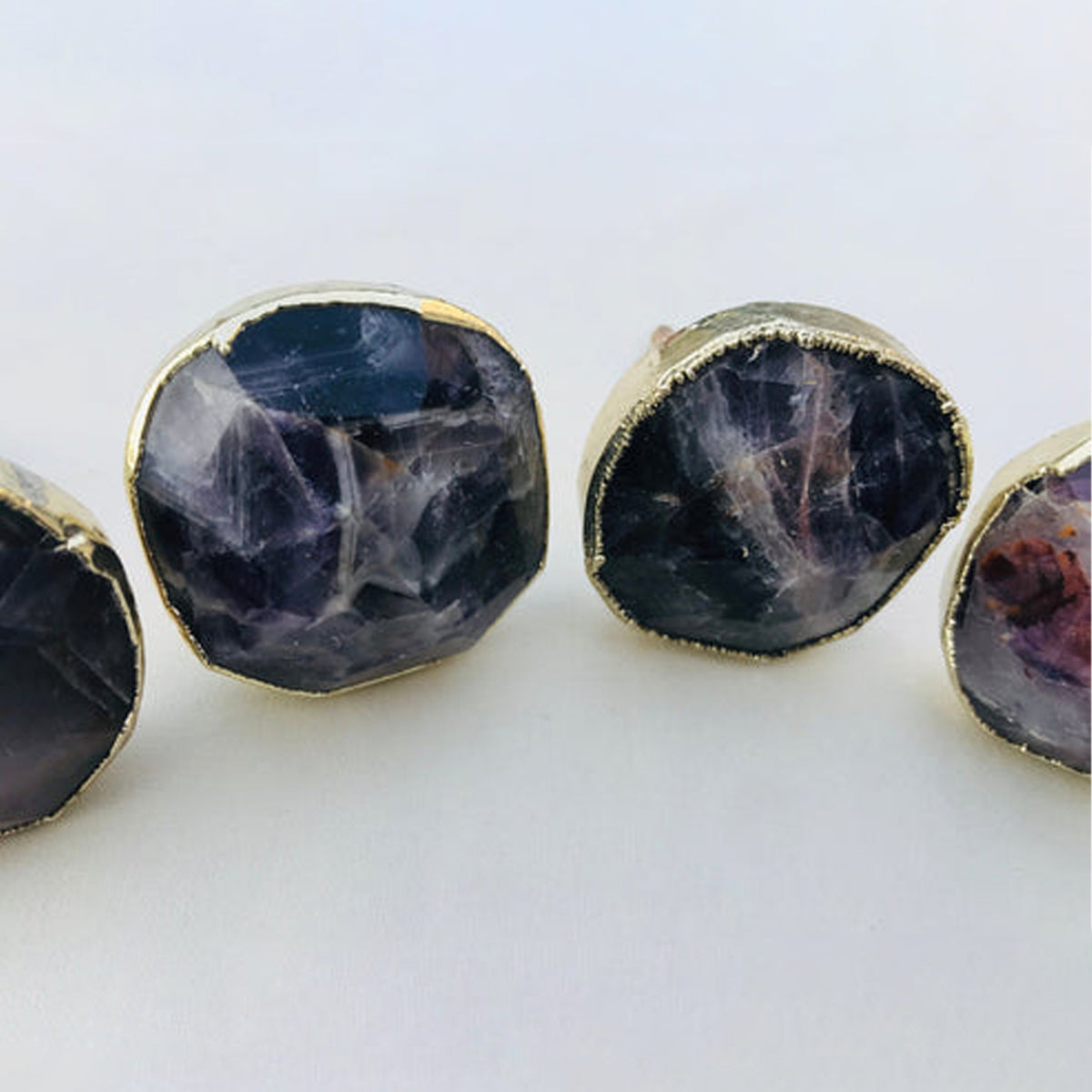Close-up of faceted amethyst knobs, deep purple with pale streaks