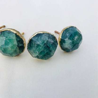 Three faceted green fluorite knobs in a row, deep teal with paler streaks