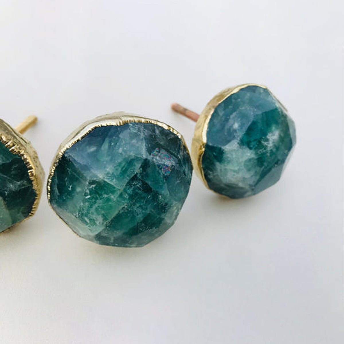Close-up of faceted green fluorite knobs in sea green and teal