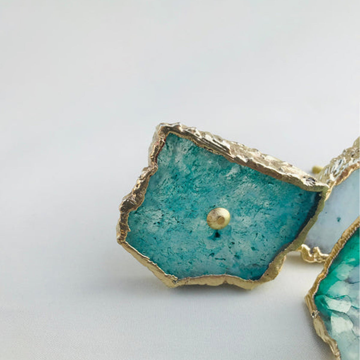 Close-up of aqua agate slice knobs with crystal centers and gold edges
