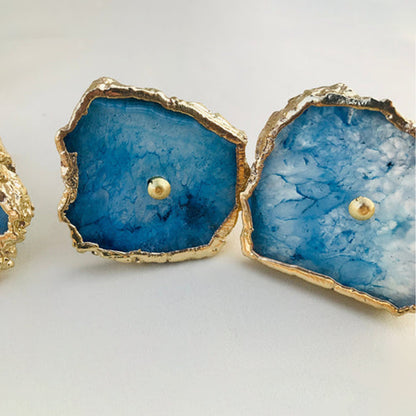 Closer view of two blue agate slice knobs, deep blue fading to white crystal