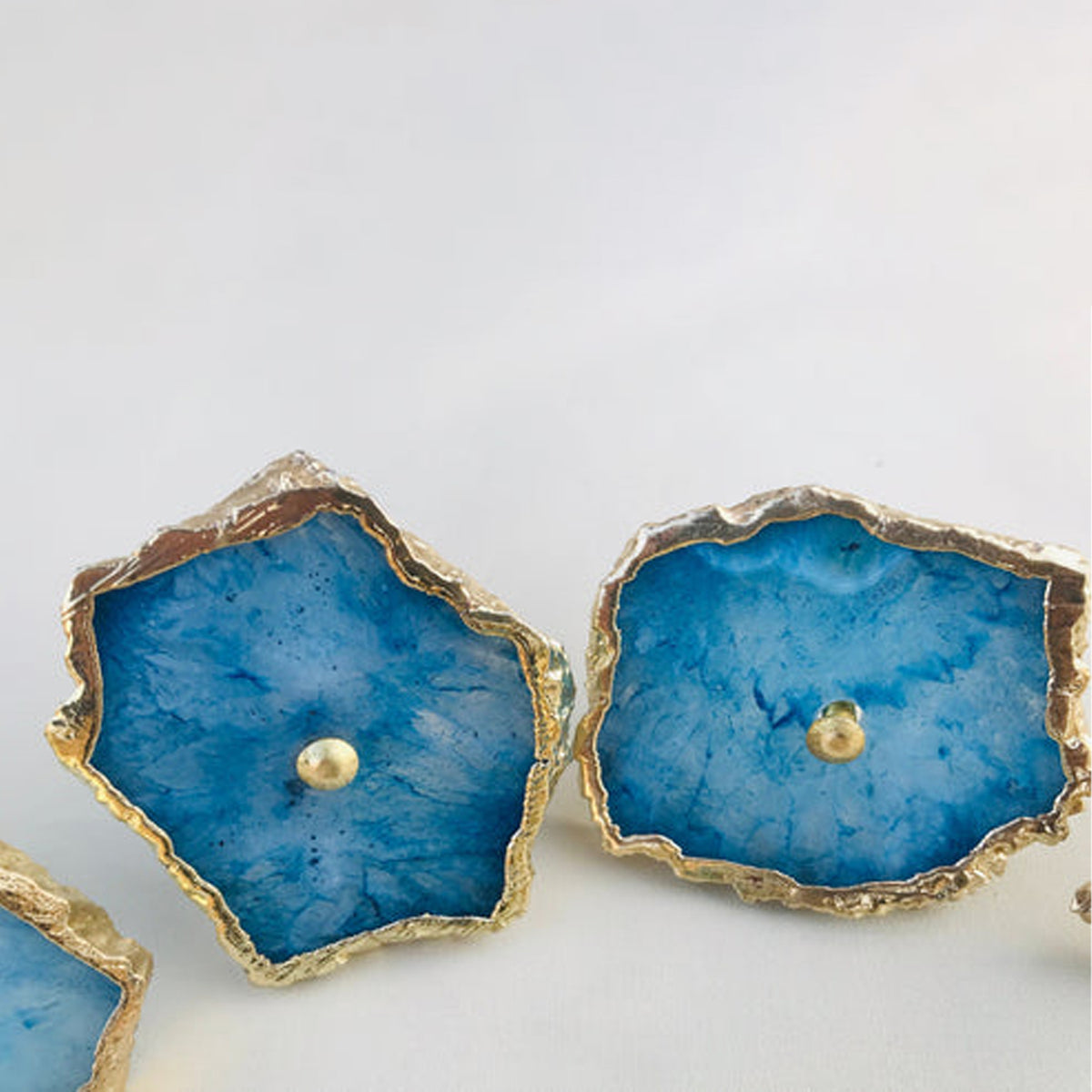Blue agate slice knobs, mottled with white crystal centers, with gold edges