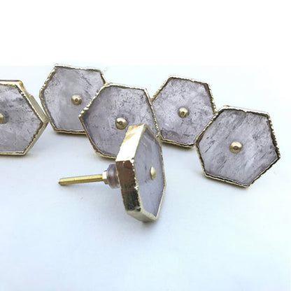 Clear quartz hexagon knobs with gold edges, one turned to show its bolt