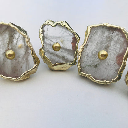 Clear quartz slice knobs up close, the middle one tilted back