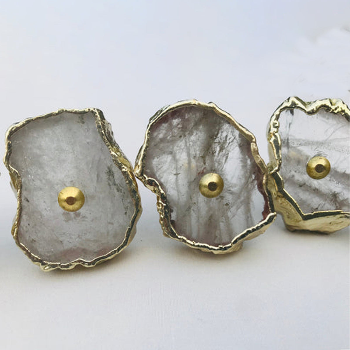 Close-up of clear quartz slice knobs with gold edges