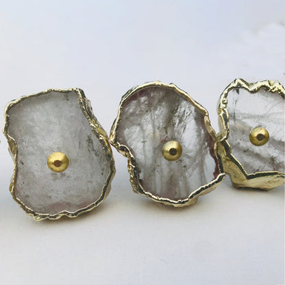Close-up of clear quartz slice knobs with gold edges