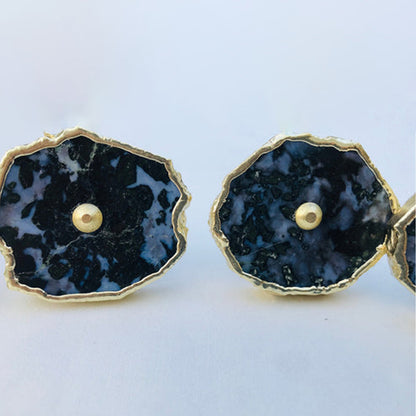 Two gabbro slice knobs side by side, mottled black and gray with center pins