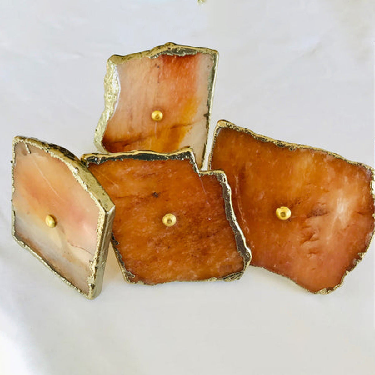Four golden agate slice cabinet knobs in amber and cream with gilded rims