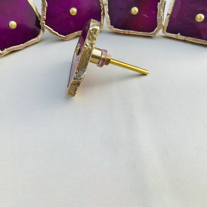 Magenta agate slice knobs, one turned to show its bolt