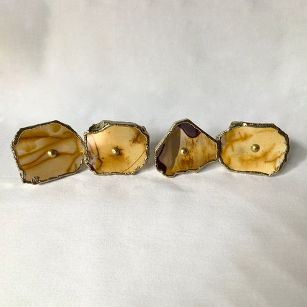 Four mookaite slice cabinet knobs in tan and cream with gilded rims