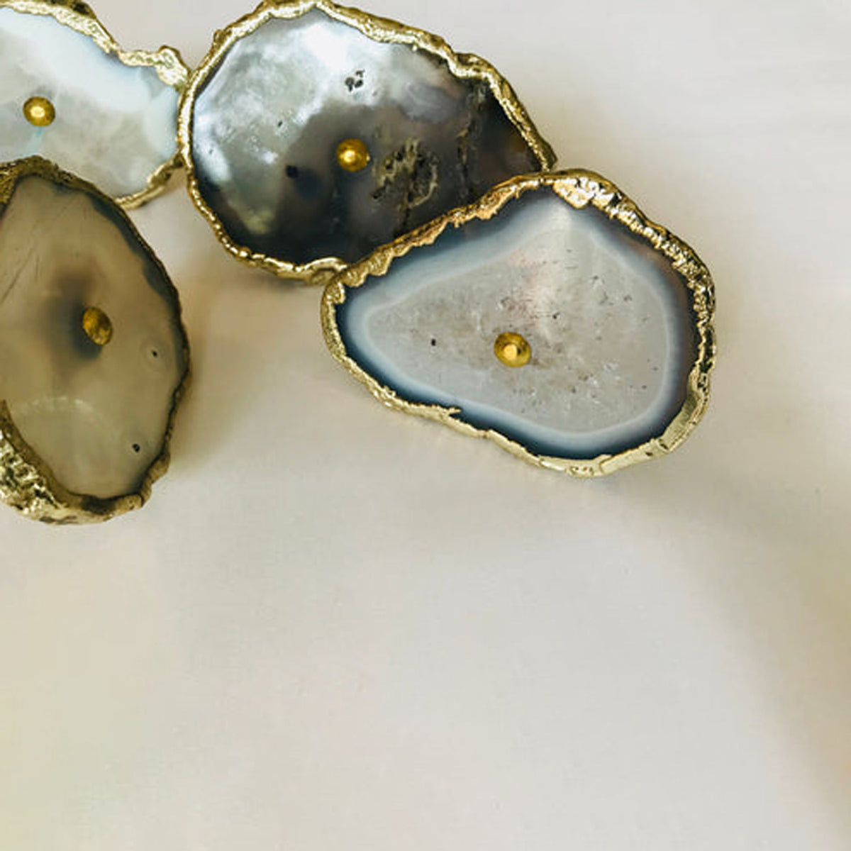Gray agate slice knobs up close, one standing on its edge at the left