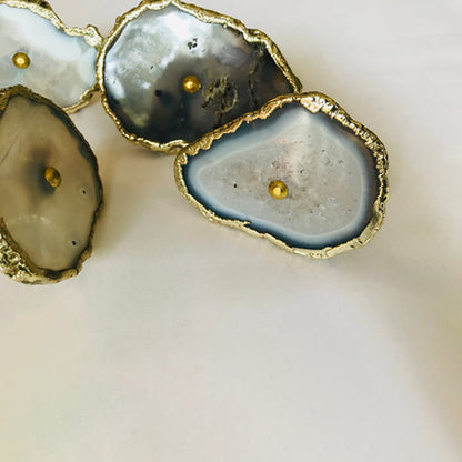 Gray agate slice knobs up close, one standing on its edge at the left