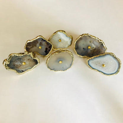 Gray agate slice cabinet knobs with gilded rims, laid in a loose group