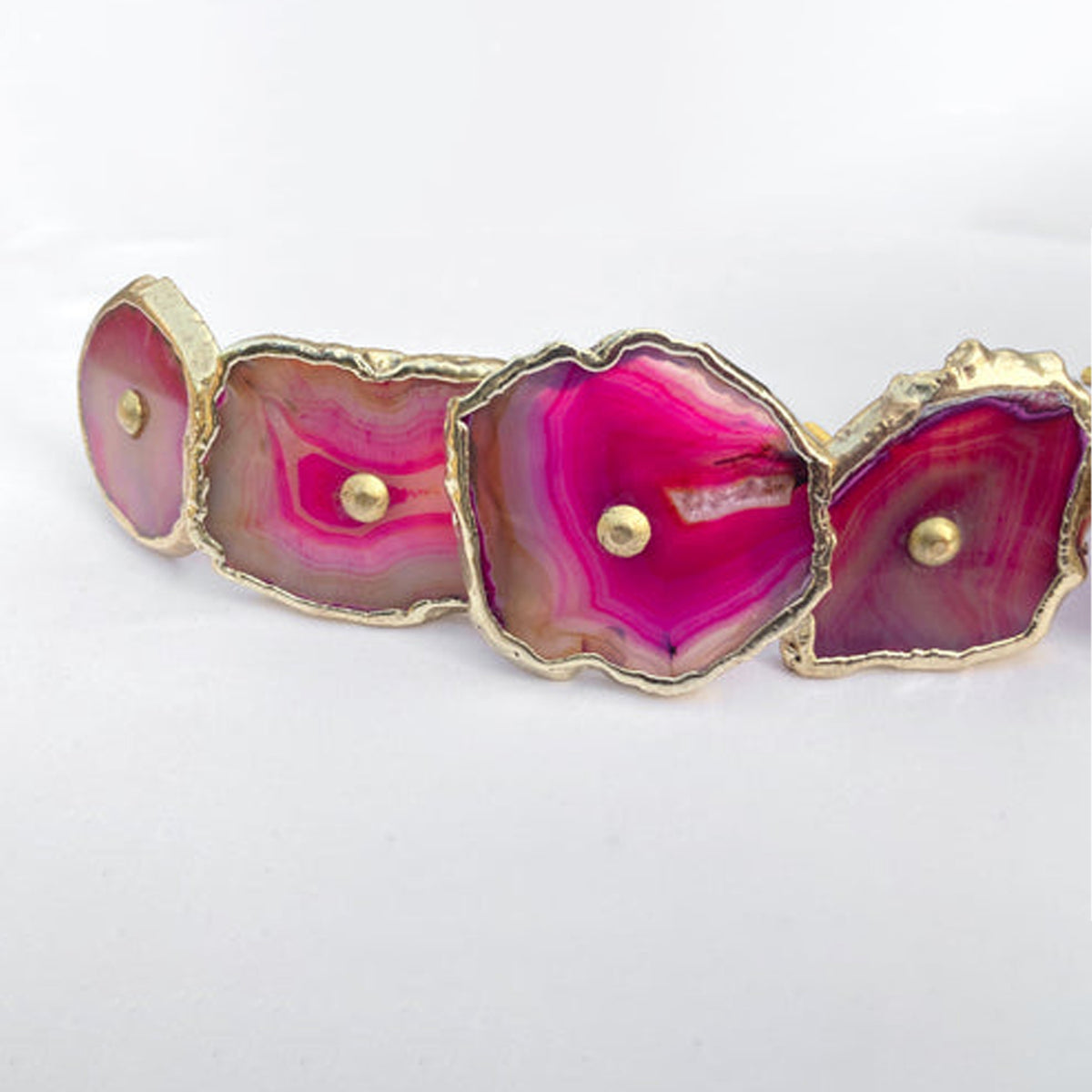 Row of pink agate slice knobs with white crystal centers