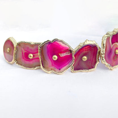 Close-up of pink agate slice knobs with gold edges and center pins