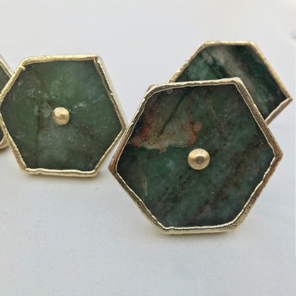 Close-up of sage green agate hexagon knobs with brass center pins