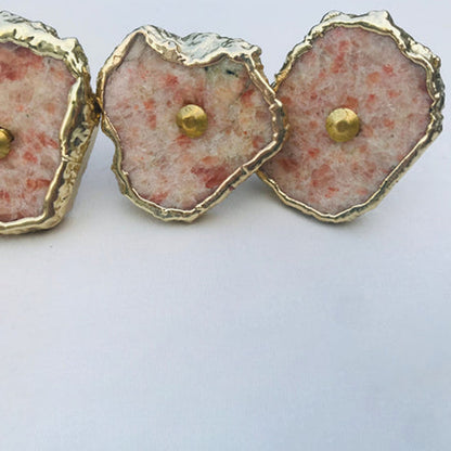 Close-up of sunstone slice knobs with red flecks
