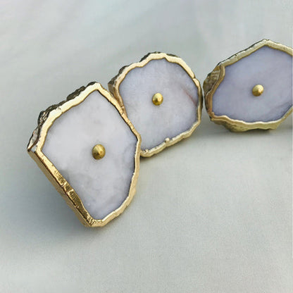 White agate slice knobs with the front one tilted toward the camera