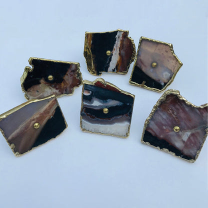 Zebra agate slice cabinet knobs in black, white and brown bands with gold edges