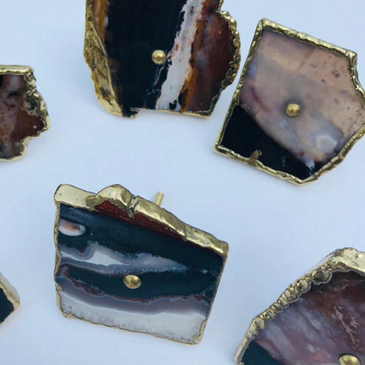 Zebra agate slice knobs banded in black, mauve-brown and white, with gold edges